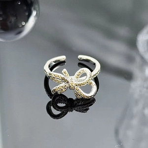 Detailed macro view of silver bow ring set with sparkling yellow cubic zirconia stones