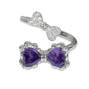 Macro shot of silver open ring with purple heart-shaped stones and butterfly design