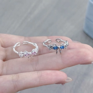 Detailed shot of adjustable butterfly rings with pink and blue pear-shaped zircon stones