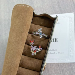 Close-up of luxury silver butterfly rings with colorful cubic zirconia in a jewelry tray