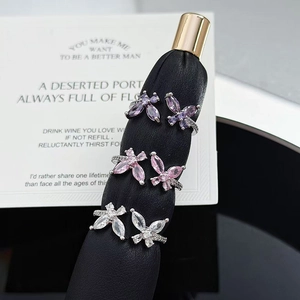 Elegant butterfly zircon open rings with purple and pink stones on black velvet display