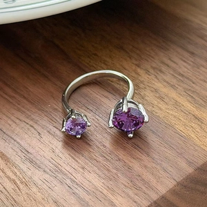 Macro detail of silver open ring with dual purple zircon stones in four-claw settings