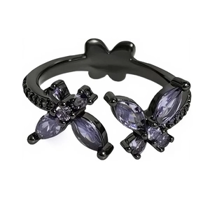Elegant butterfly open ring in black metal with purple zircon stones on a white background