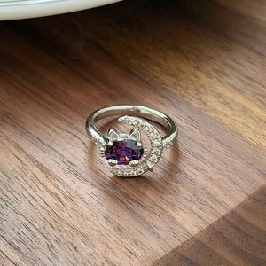 Detail of silver cat and moon ring with purple oval stone and white zircon pavé