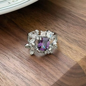 Detailed macro view of square purple zircon ring with silver floral petal setting