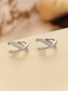 Detailed view of silver X-shaped ear cuffs with micro-pave cubic zirconia stones