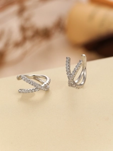 Detail shot of silver crisscross ear cuff with micro-paved cubic zirconia stones