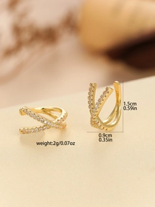 Detail view of gold crisscross ear cuffs with pink cubic zirconia and size dimensions