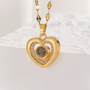 Detailed view of a gold heart pendant with zircon pavé and center projection stone