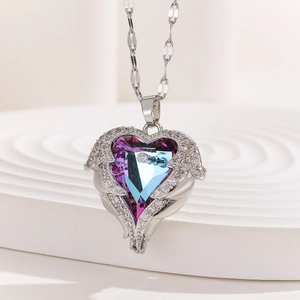 Detail of angel wing heart necklace with purple-blue gradient crystal and silver chain