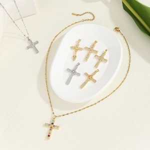 Detailed arrangement of gold and silver cross pendants with zircon on a ceramic tray