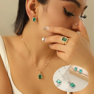 Vintage jewelry set with emerald-cut green zircon earrings, necklace, and ring for women