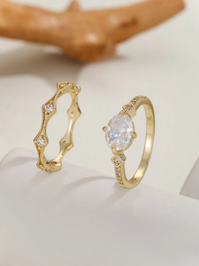 Macro shot of gold-plated rhombus zircon ring set with vintage wave band and oval stone