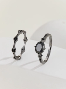 Detail of gothic style black gemstone ring set with rhombus zircons in dark metal finish