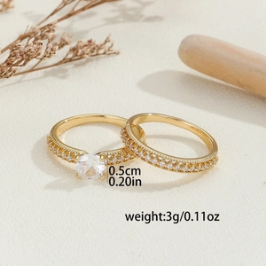 Luxury gold hollow rings set with micro-inlaid zircon stones on a rustic background