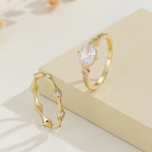 Luxurious gold-plated ring set with an oval zircon centerpiece and wavy pavé band