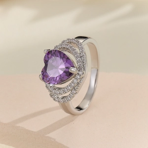 Macro shot of a heart-shaped purple zircon ring with multi-layer pavé setting details
