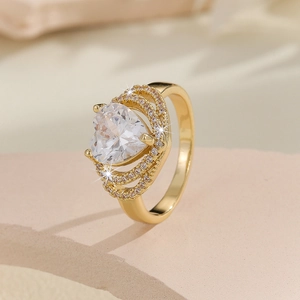 Detailed macro view of large heart-shaped zircon ring with layered gold setting