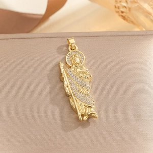 Macro view of gold-plated St. Jude pendant with micro-paved white cubic zirconia stones