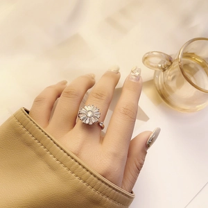 Elegant adjustable silver sunflower ring with baguette zircon petals worn on a finger