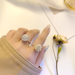Close-up of rotatable sunflower rings with zircon inlay and adjustable open band design