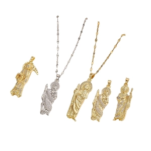 Saint Jude and Santa Muerte gold pendants with sparkling cubic zirconia on white background