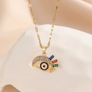 Detail of gold Evil Eye pendant with colorful zircon stones and purple crystals