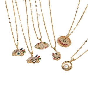Gold evil eye necklaces with colorful zircon stones in various eye designs on white background
