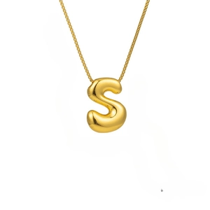 Macro shot of 3D bubble letter S pendant with high-polished gold finish on square box chain
