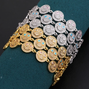 Macro detail of smiley face pendants with colorful cubic zirconia on linked chains