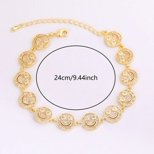 Detail of gold smiley face bracelet with white cubic zirconia and adjustable chain