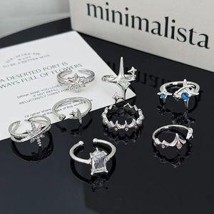 Set de 7 anillos plateados con circonitas brillantes estrella y luna ajustables mujer