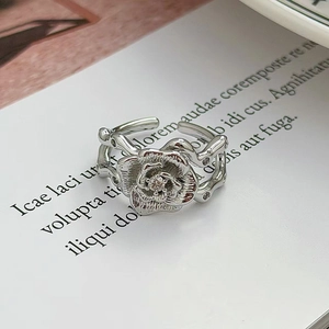 Macro di un anello a rosa argento con pietre pavé e fascia testurizzata regolabile