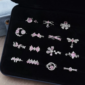 Set di 15 anelli color argento con cristalli rosa fiocchi stelle e motivi floreali