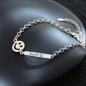 Minimalist silver smiley face chain bracelet with adjustable clasp and smile pendant