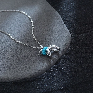 Polished silver balloon dog necklace with blue turquoise beads on a fine O-chain