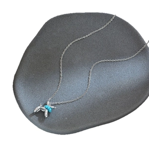 Silver balloon dog necklace with turquoise bead on a grey stone base for women