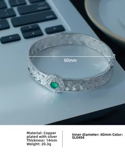 Close-up of woven silver bangle with 14mm thickness and green gemstone center