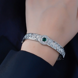 Silver woven lace bangle with green faux jade stone and white zircons for women