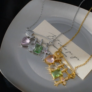 Safety pin cross necklace with colorful zircon stones in silver and gold finishes