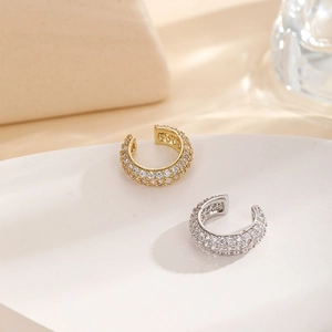 Macro shot of gold and silver C-shaped ear cuffs with micro-pave cubic zirconia