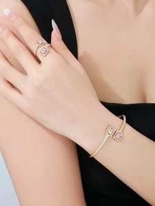 Detail of gold-plated bangle and ring set with micro-paved cubic zirconia accents