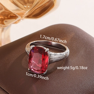 Macro view of vintage silver ring featuring bark texture and square red zircon gemstone