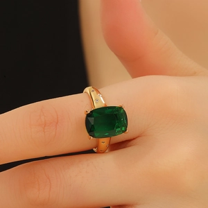 Elegant gold ring with rectangular emerald stone and side diamonds for women