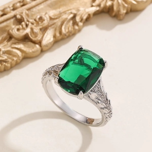 Macro shot of vintage silver ring featuring a large rectangular emerald green stone