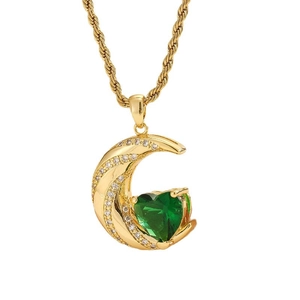 Golden crescent moon necklace with green heart gem and white crystals on twisted chain