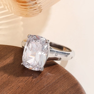 Macro detail of a cushion-cut zircon ring with sparkling side stones and silver finish