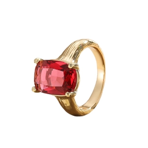 Luxurious gold-plated ring featuring a large red cushion-cut zircon with textured band