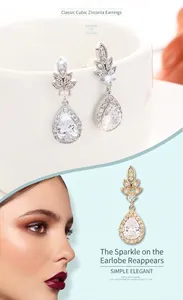Dettaglio di orecchini a goccia in zircone argento e oro con montatura a forma di foglia