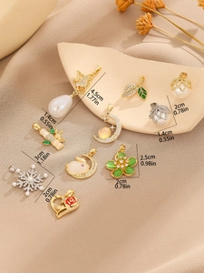 Detailed view of various vintage Chinese style charms with pearls and floral motifs